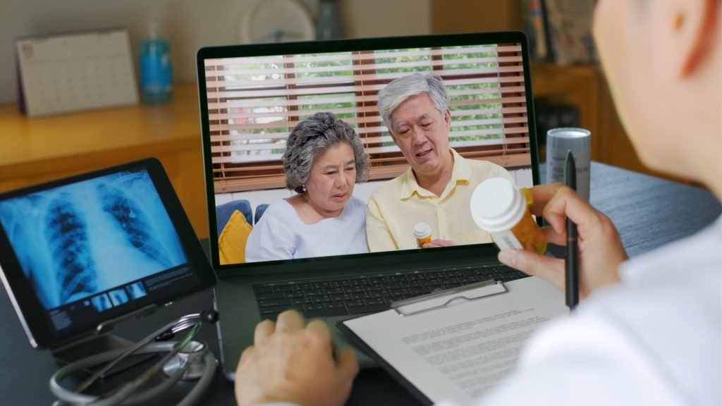Telehealth concept,doctor video call with couple senior about prescription on digital tablet